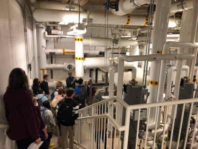 People walking down stairs in a large facility