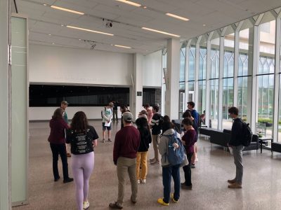 People standing in the large atrium of a building