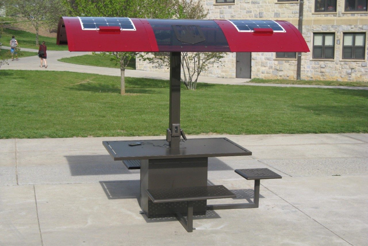Solar table complete installation with one phone charging in the center.