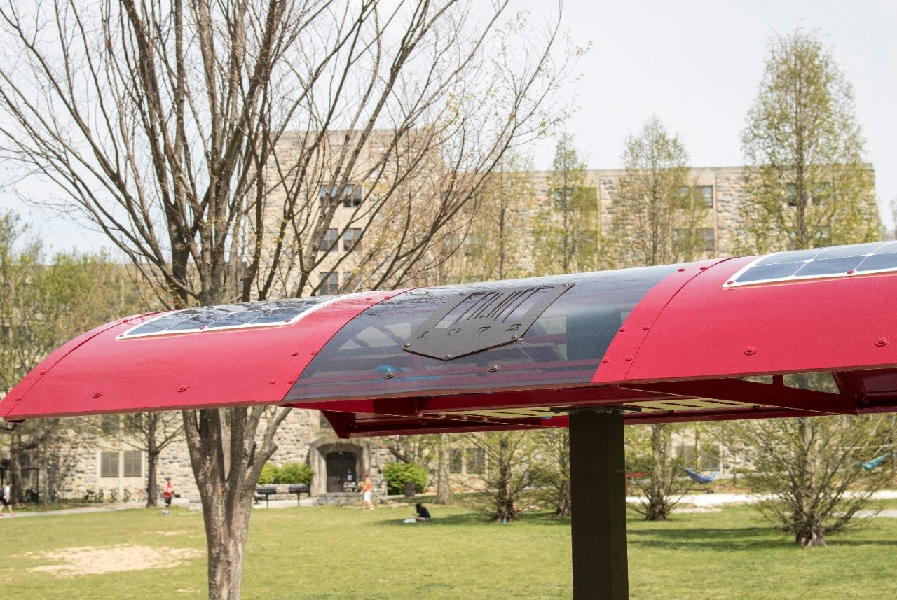 The top of the solar table has multiple solar panels and a metal cut out of the Virginia Tech shield.