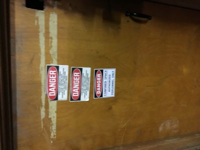 Photo of a confined space door with proper labeling. 