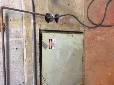 Photo of a confined space door with proper labeling. 