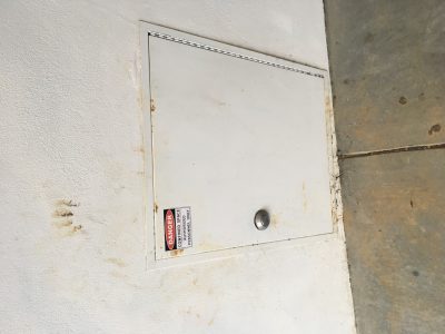 Photo of a confined space door with proper labeling. 