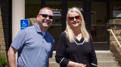 Jon Clark Teglas, chief of staff, stands next to Teresa Thompson at the VTPDs annual hotdog fundraiser in front of the public safety building