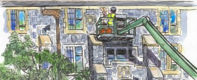 New windows are being installed on a campus building by a person in a lift