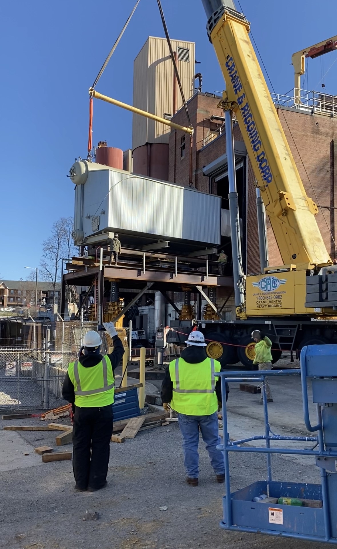 Boiler being lifted by crane and installed in the power plant.