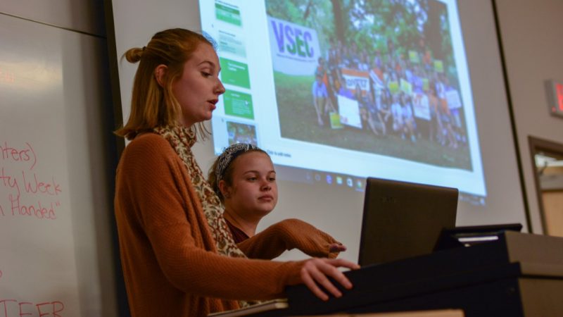 Two students discussing ways to promote sustainability.