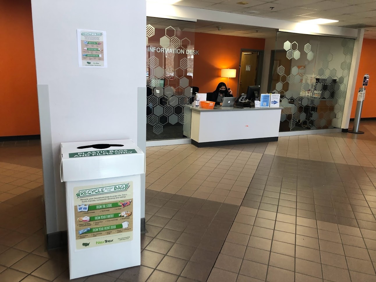 Plastic bag recycling bin located in Squires Student Center on the first floor to the left of the information desk against a large white pillar