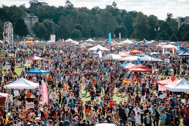 2017 Gobblerfest on the Drillfield with huge numbers of people among scattered small tents and carnival rides including a big Ferris wheel.