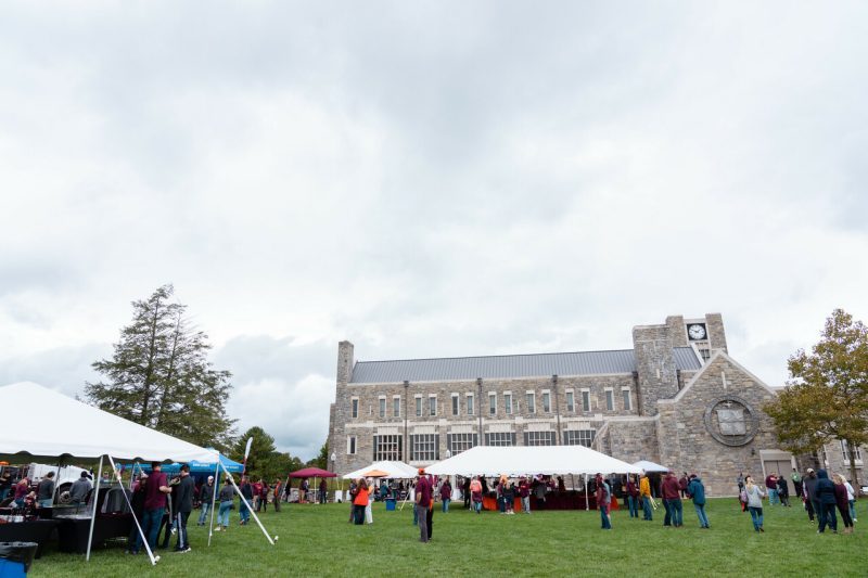 2021 Homecoming tailgate on the lawn at the Holtzman Alumni Center with large tents and lots of people.