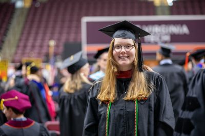 A graduate wears a green cord 