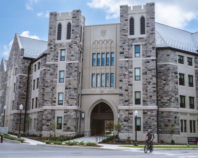 Grey Hokie Stone Upper Quad Hall North under blue skies. 