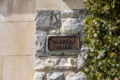 Grey Hokie Stone building with signage reading "Pamplin Hall." 