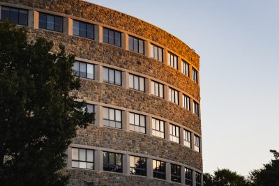 Grey Hokie Stone Newman Library during sunset. 