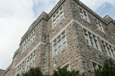 Grey Hokie Stone Patton Hall. Cloudy skies are above. 