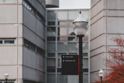 Durham Hall featuring exterior windows and signage on a lamp post. 