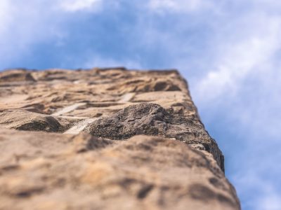 Grey Hokie Stone surrounded by blue skies. Sunlights shines down from above. 