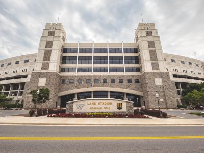 Grey Hokie Stone Lane Stadium under blue skies. 