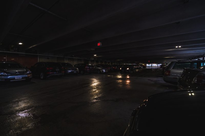 Perry Street Parking Garage in the dark. Cars are parked in parking spots throughout the image. 